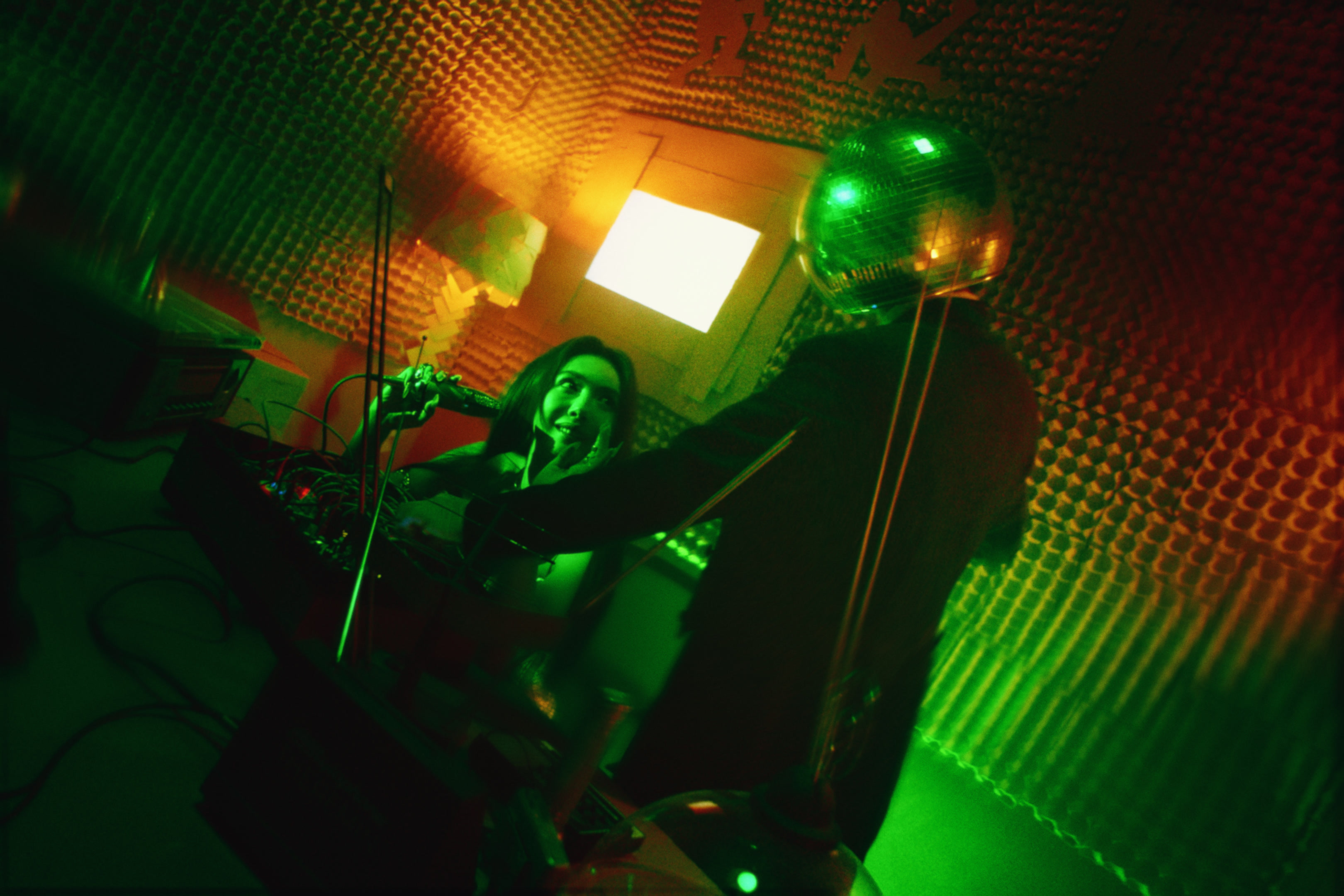 340 — Elvira Cai in a green-lit recording studio