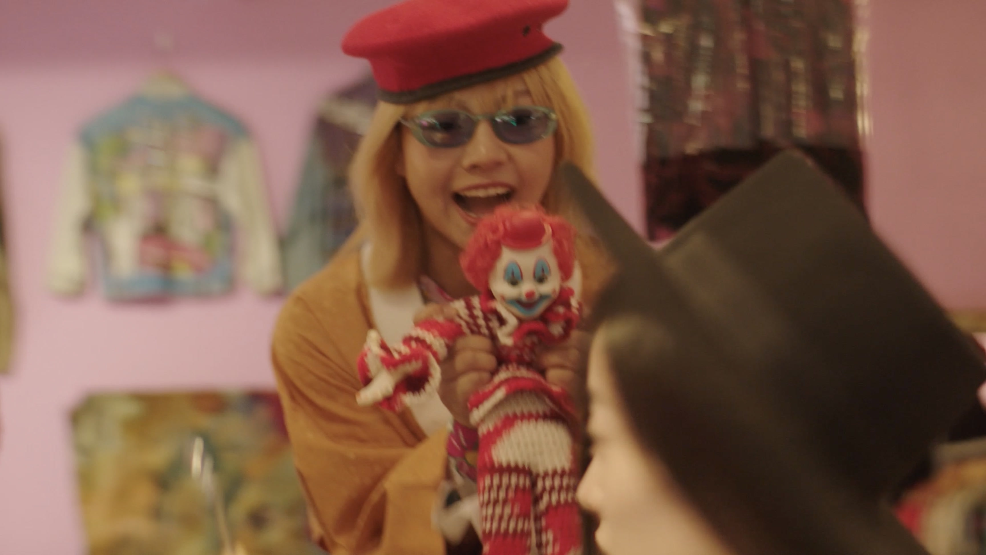 A girl holding a clown doll