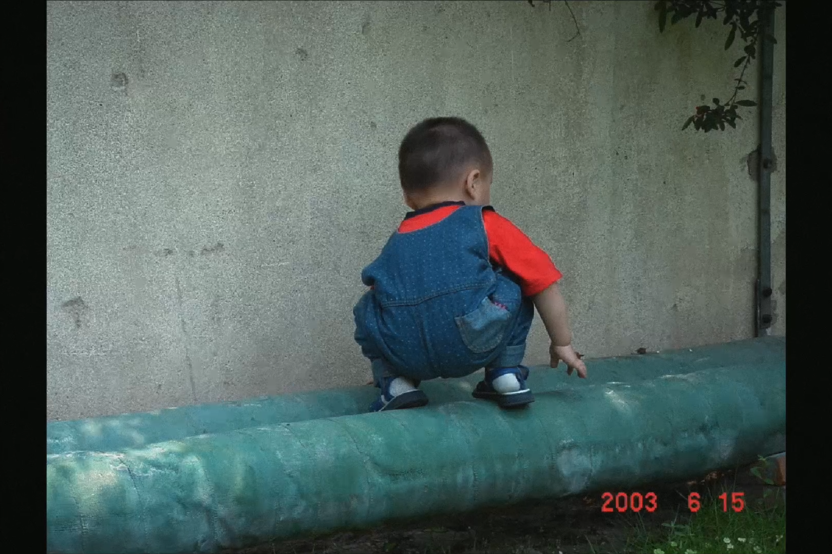 A child crouching on a pipe, 2003