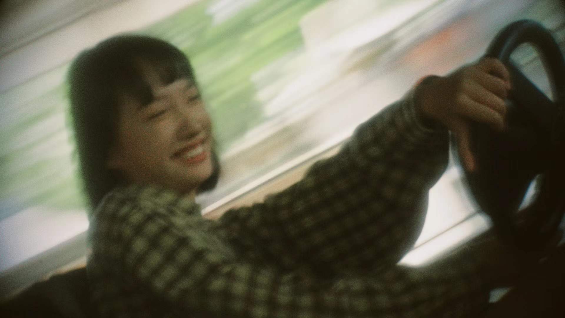 A smiling woman at the wheel