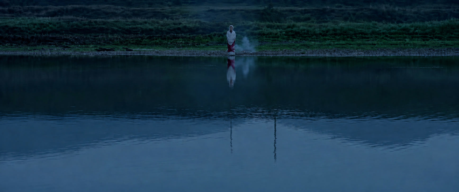 GRANDMA'S FUNERAL — a distant figure by the water