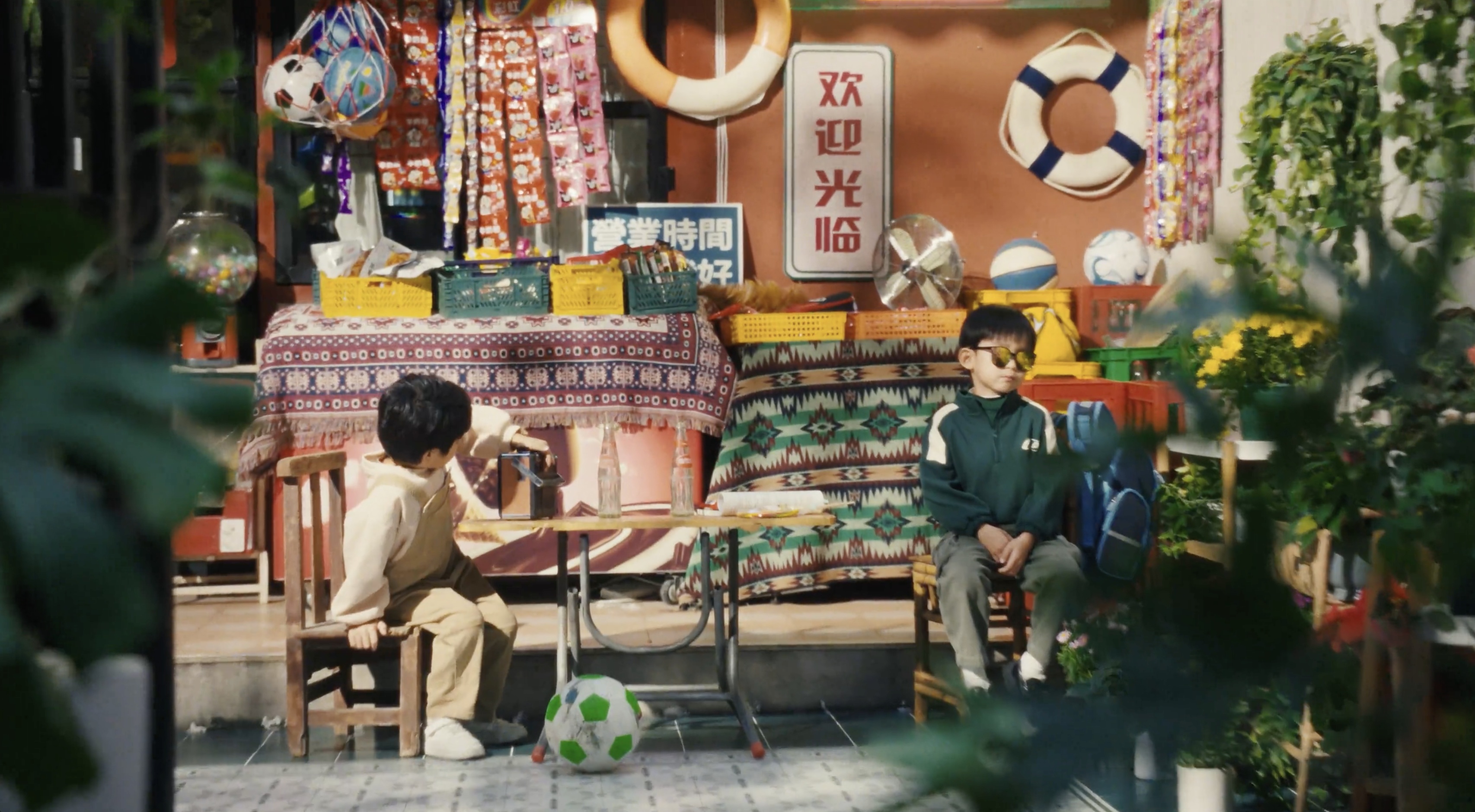 Two children outside a colourful shop