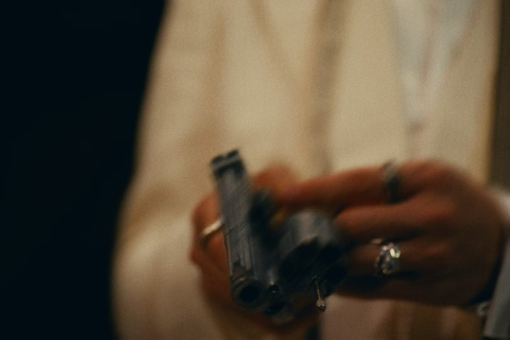 A close-up of hands holding a pistol