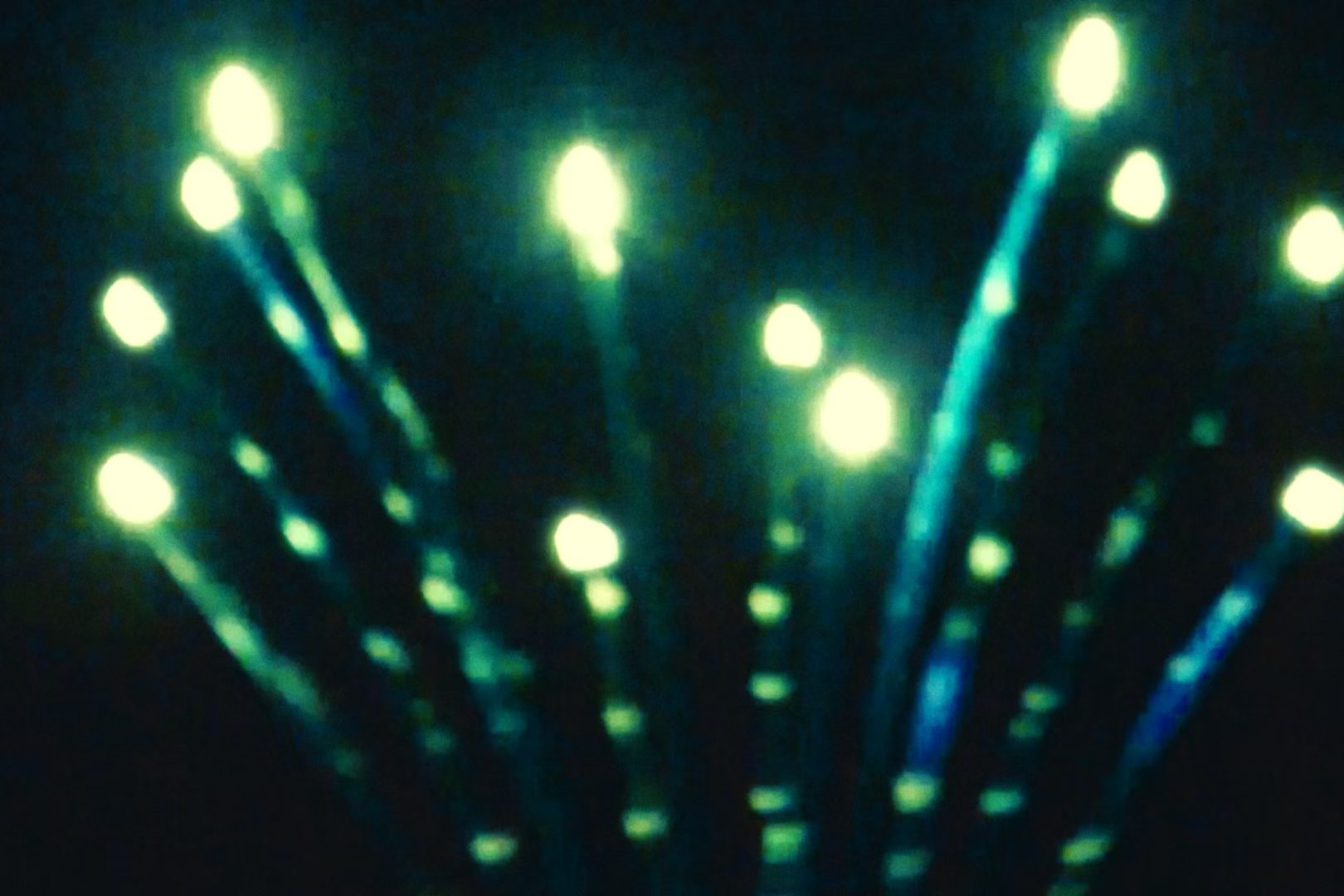 Soft green lights against darkness