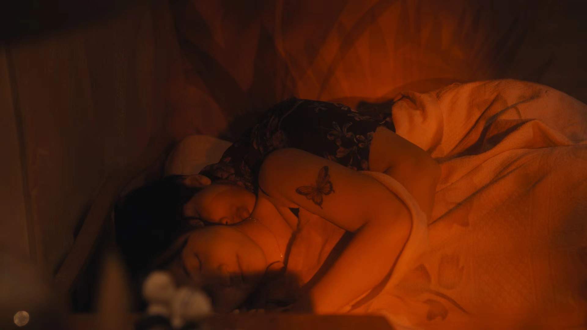 A WRETCHED LIFE — two figures resting in warm red light