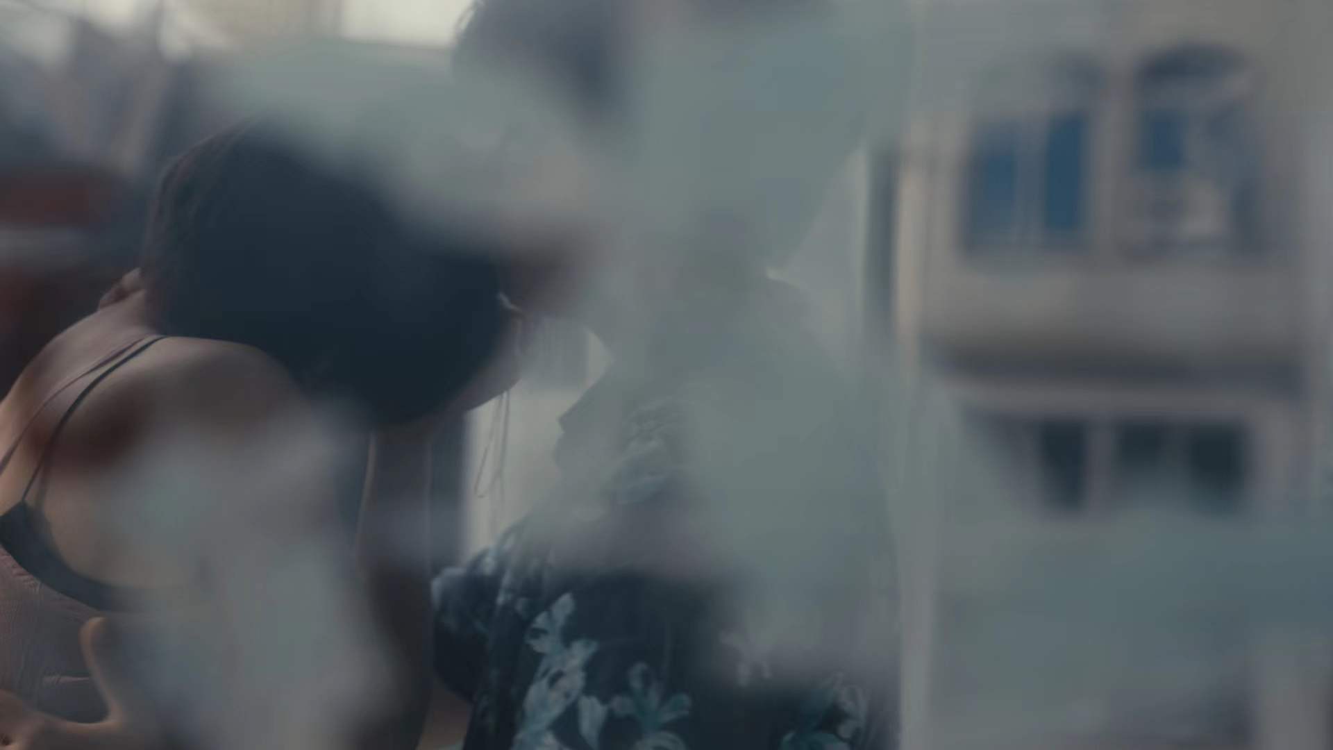 Two figures seen through a window