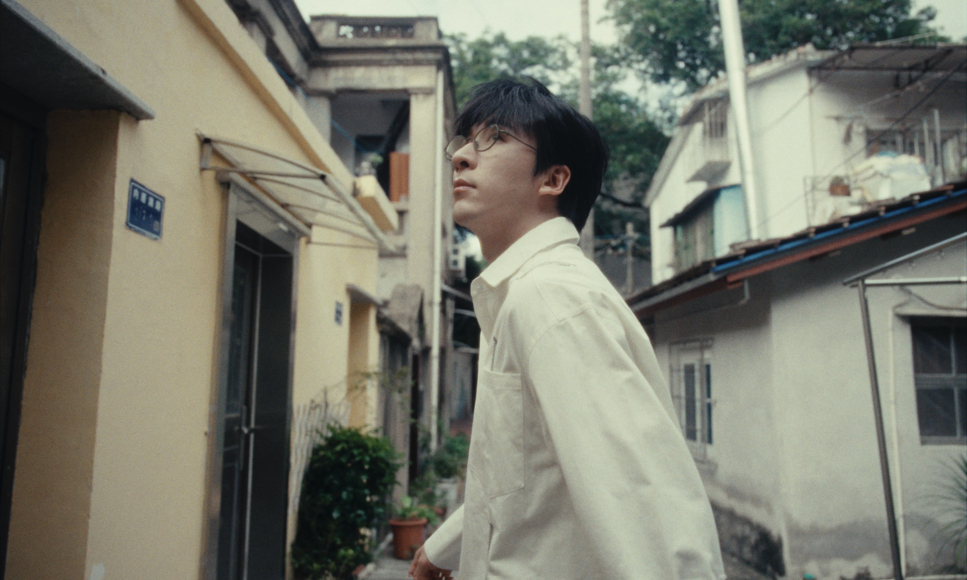 Sean Tang walking along a quiet street