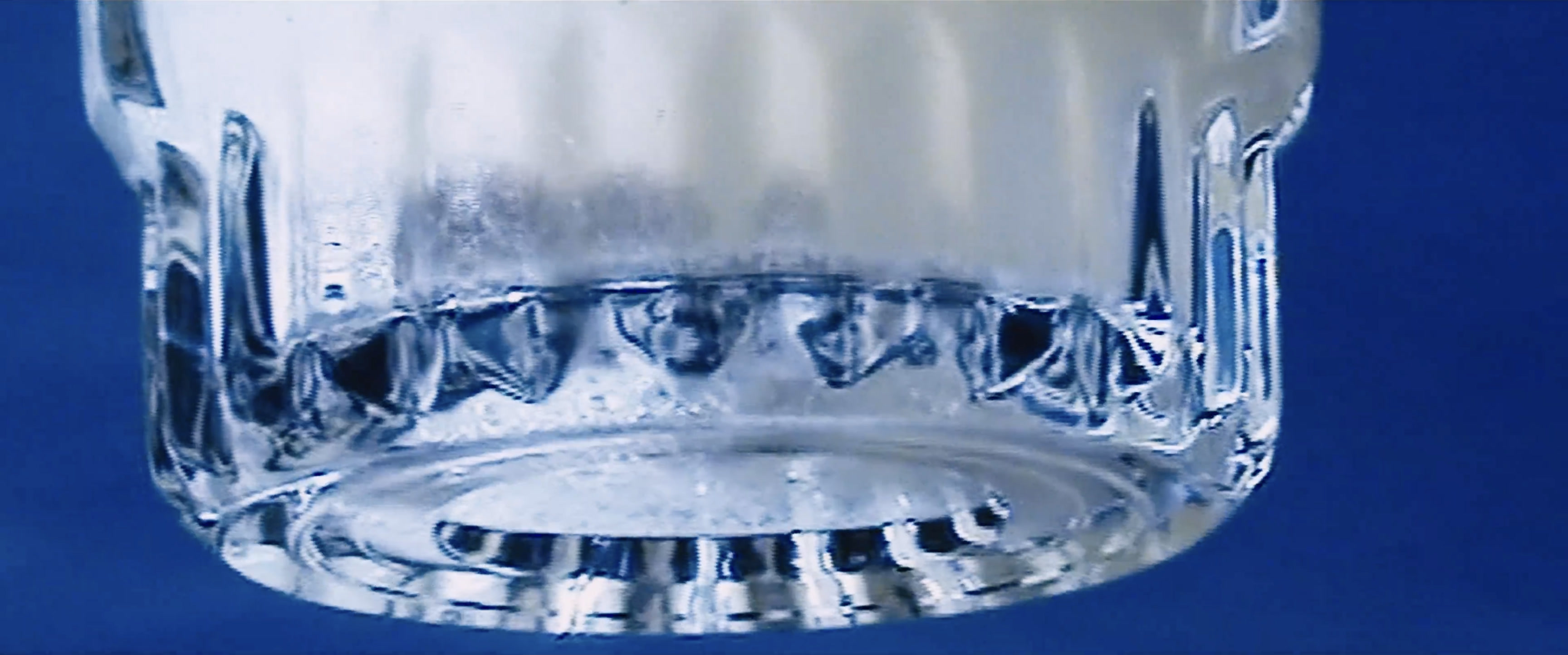 A glass against a blue background