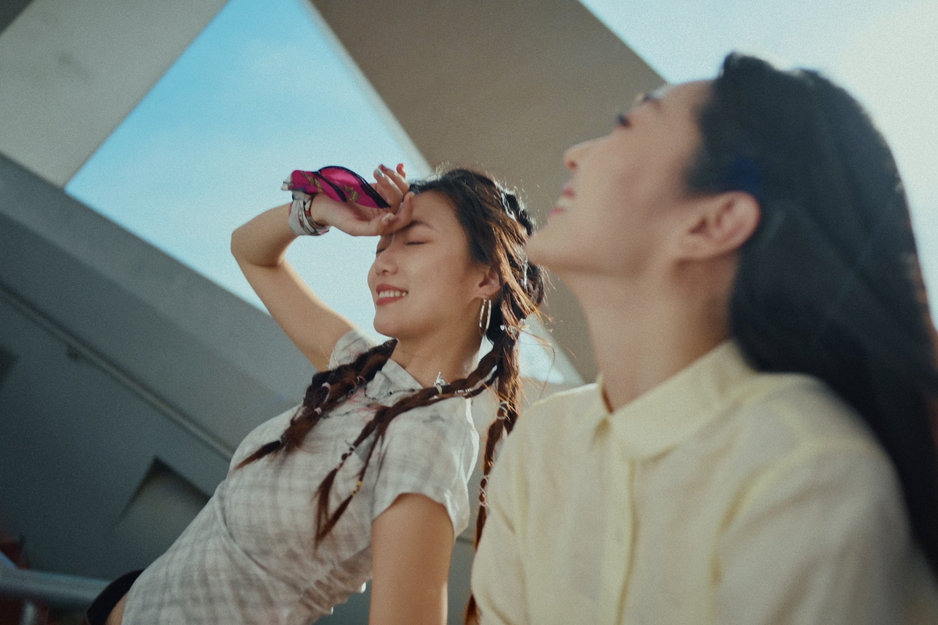 Two women beneath a geometric ceiling