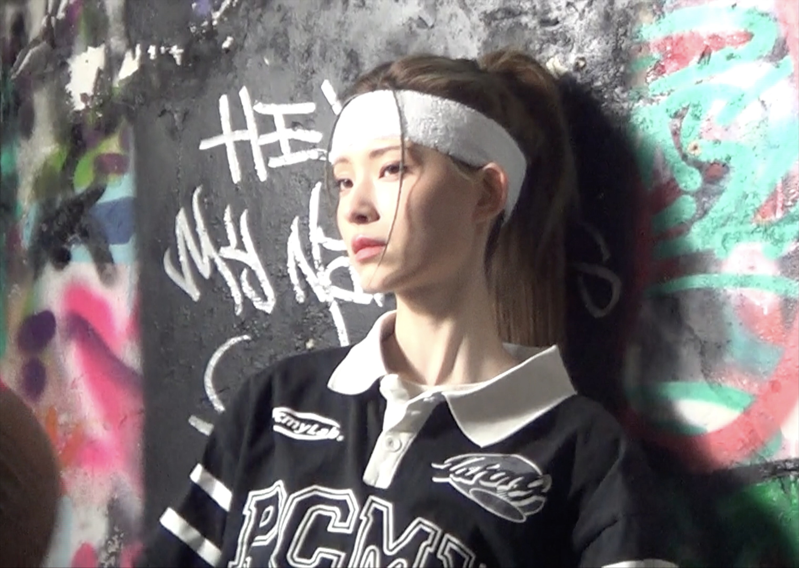 A portrait against a colourful graffiti wall