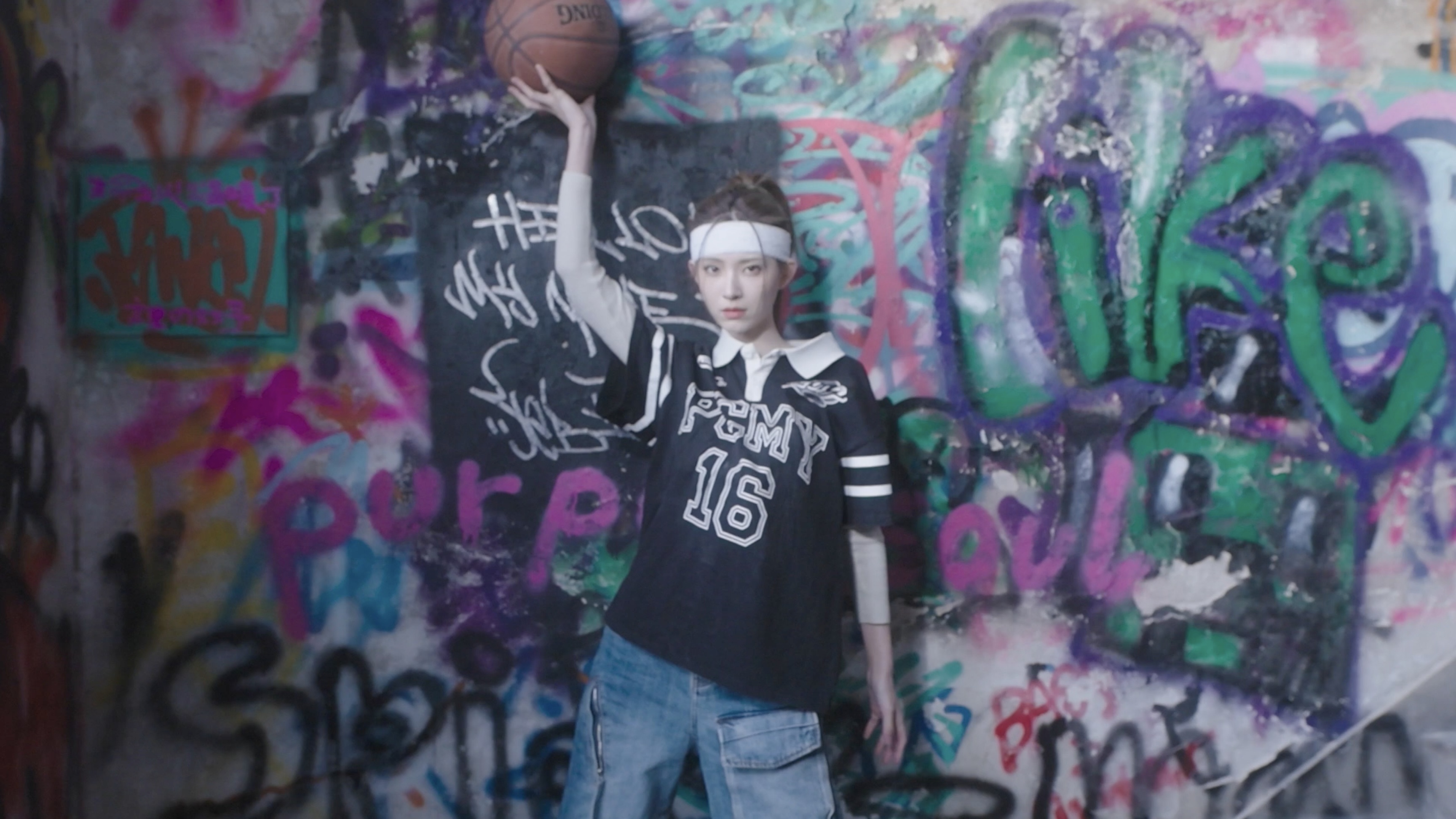 A woman holding a basketball above her head