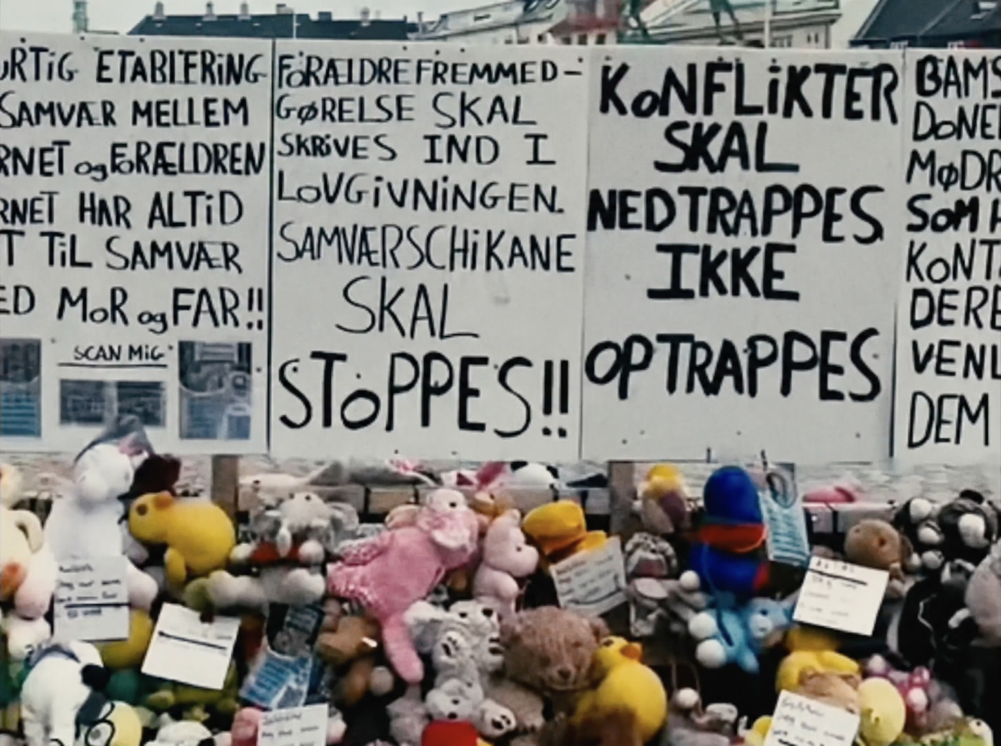 Handwritten signs above a collection of toys