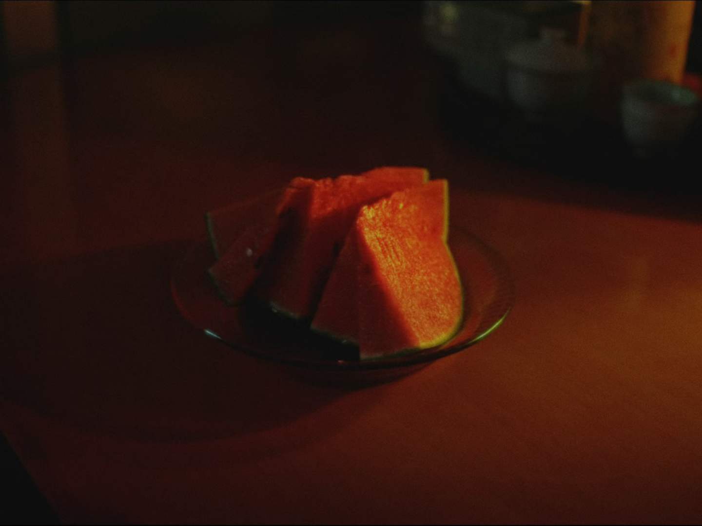 Watermelon slices on a table in warm light