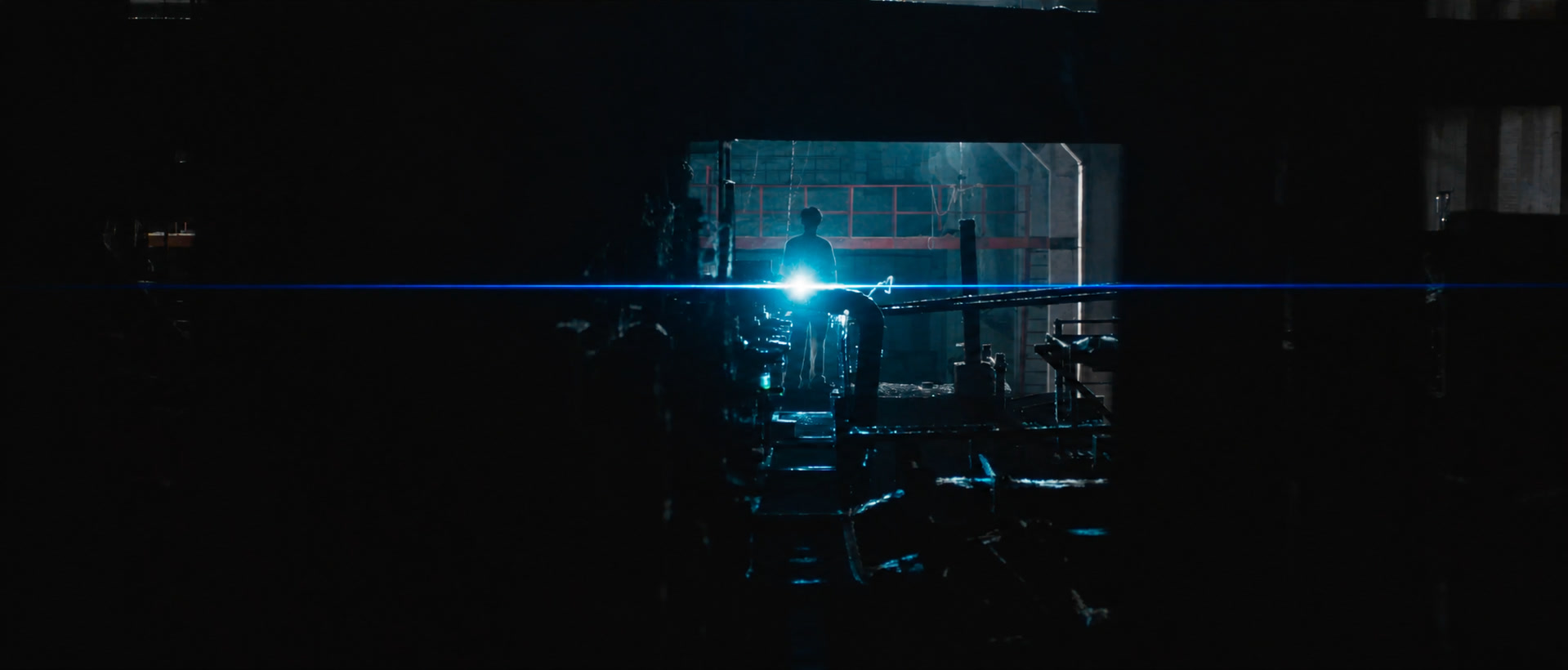 ROLLING — a figure holding a flashlight in a dark factory