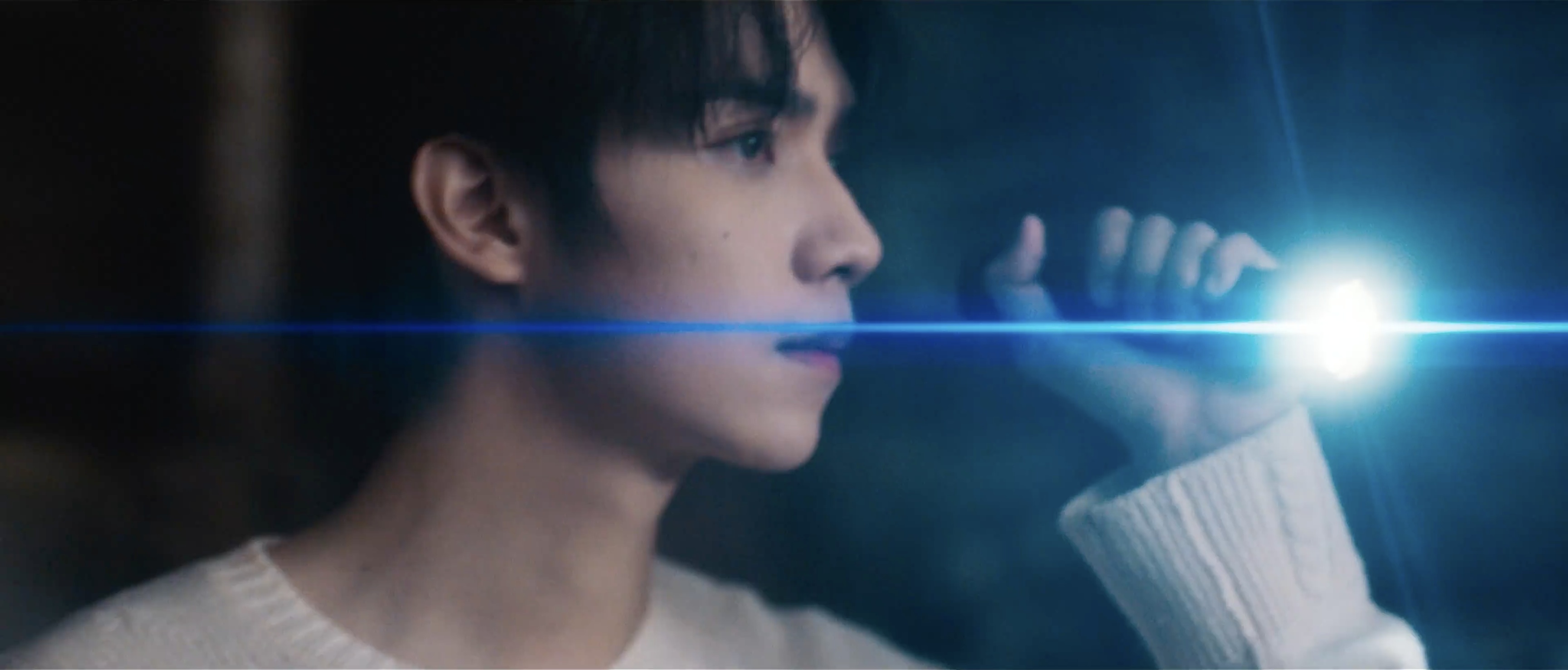 A profile illuminated by a blue flashlight