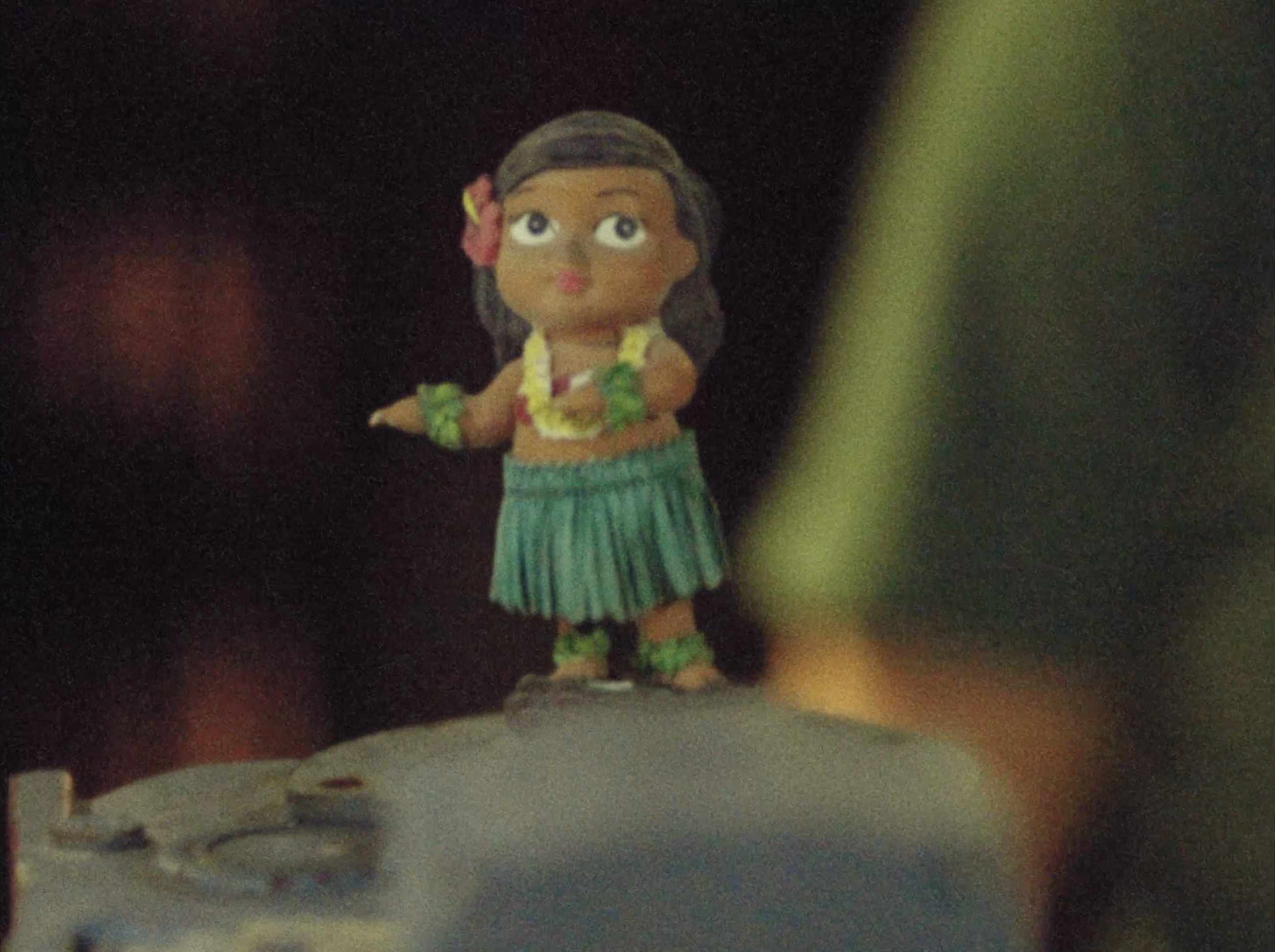 A hula figurine on a sewing machine