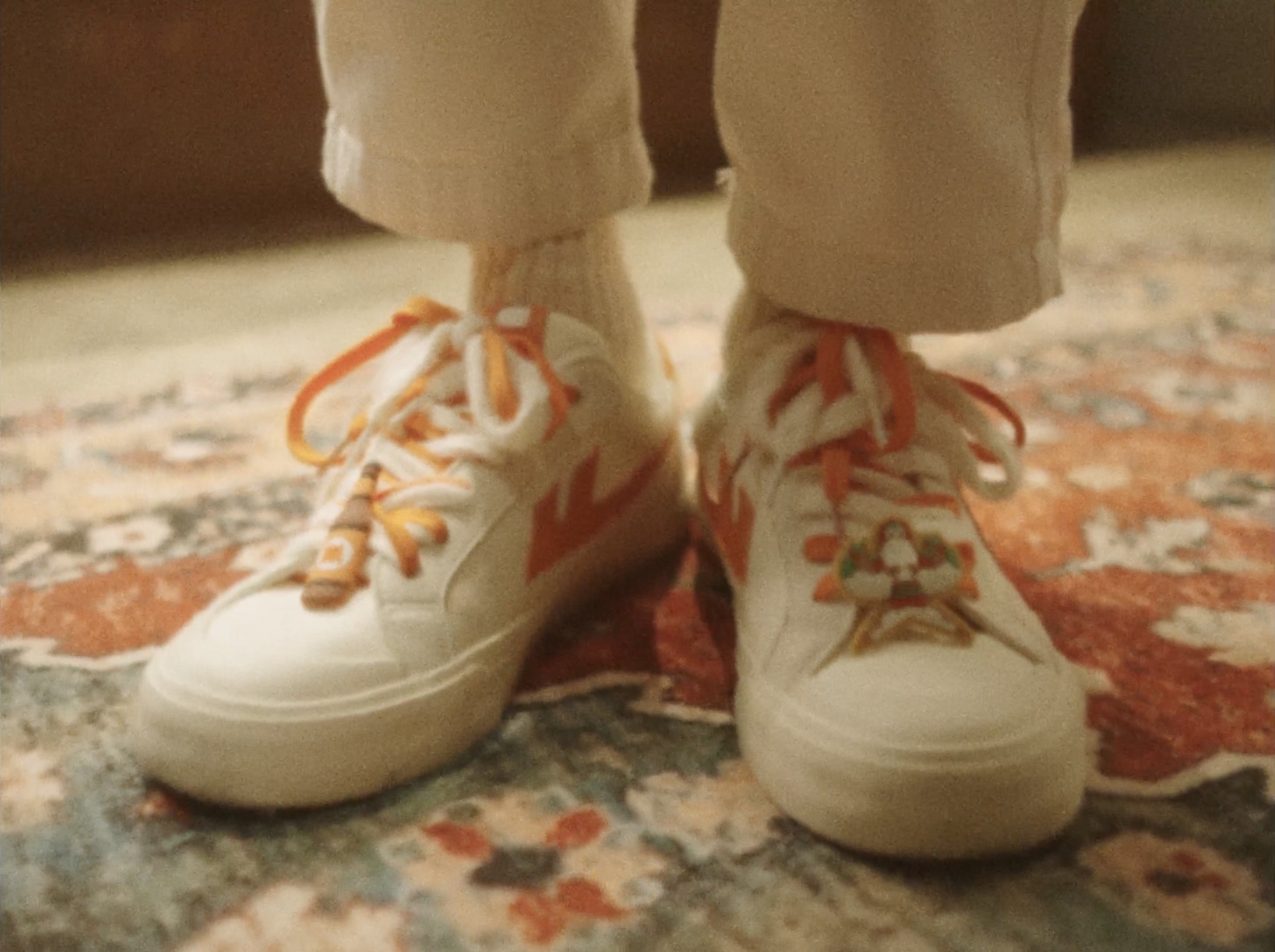 White Warrior sneakers with orange laces